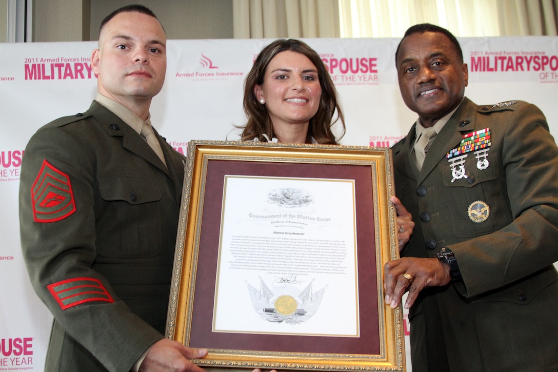 Bianca Strzalkowski, her husband Gunnery Sgt. Strzalkowski and Lt. Gen. Willie J. Williams present Bianca’s Certificate of Commendation from the commandant of the Marine Corps after she had just received the 2011 Military Spouse of the Year Award at the Navy at the Reserve Officers Association May 5. (Official U.S. Marine Corps photo by Sgt. D.R. Cotton) (released)