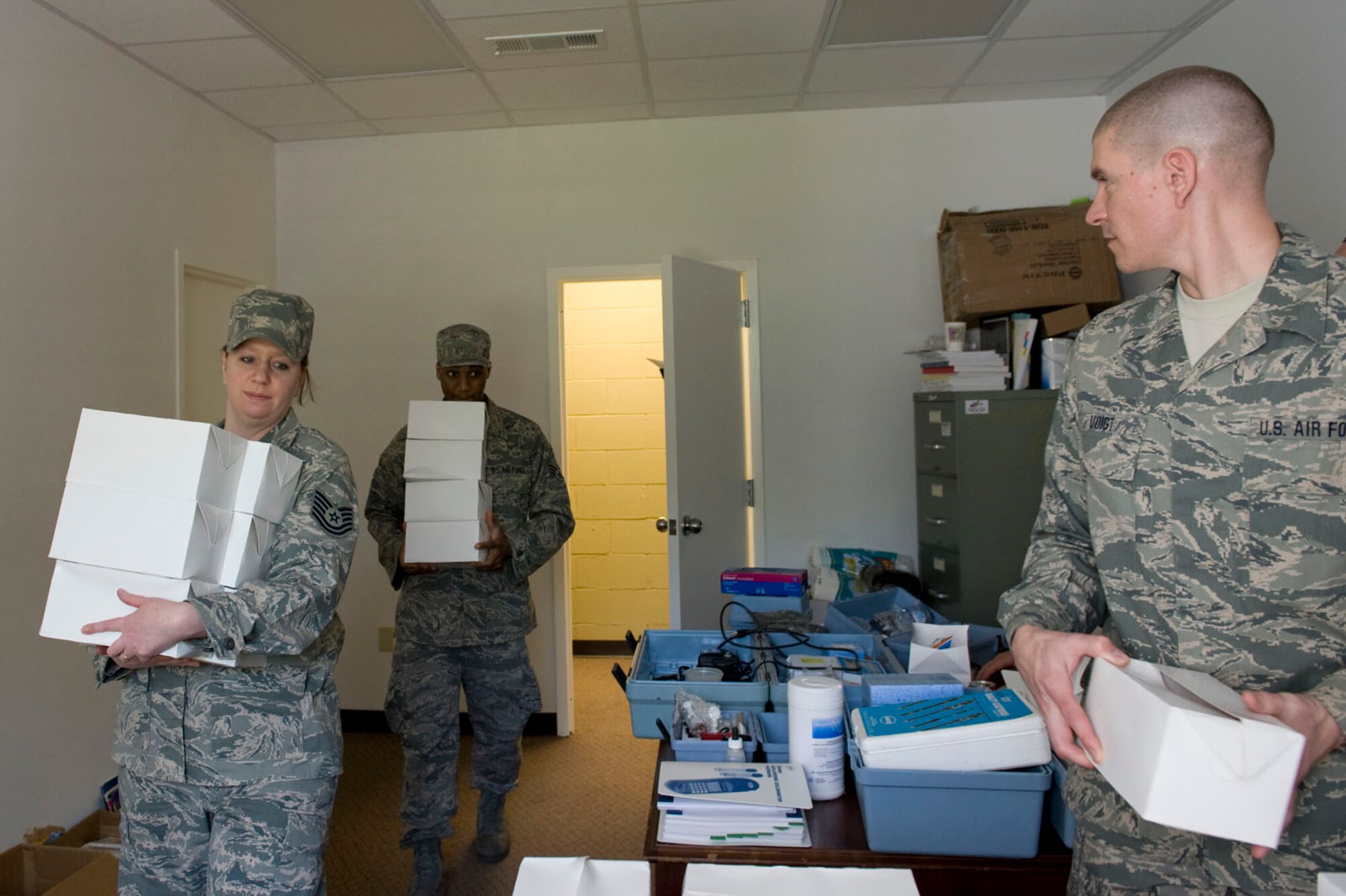 HAYNEVILLE, Ala. - Senior Airman Allen Wilson and Tech. Sgt. Trisha Willis, services technicians from the 176th Sustainment Services Element, Alaska Air National Guard, deliver box lunches to the Hayneville town hall and Master Sgt. Ryan Voigt, first sergeant for the 176th Medical Group, Alaska Air National Guard selects his box lunch from the stack, May 5, 2011. To make the lunches, Wilson and Willis had to borrow the kitchen of the 187th Fighter Wing at Dannelly Field, Ala. and truck them about 15 miles to Hayneville.  Wilson, Willis, and Voigt are in Alabama  for an Innovative Readiness Training (IRT) mission. The IRT program allows for real world training opportunities for military personnel while providing needed services to under-served communities in the United States. Alaska Air National Guard photo by Master Sgt. Shannon Oleson.