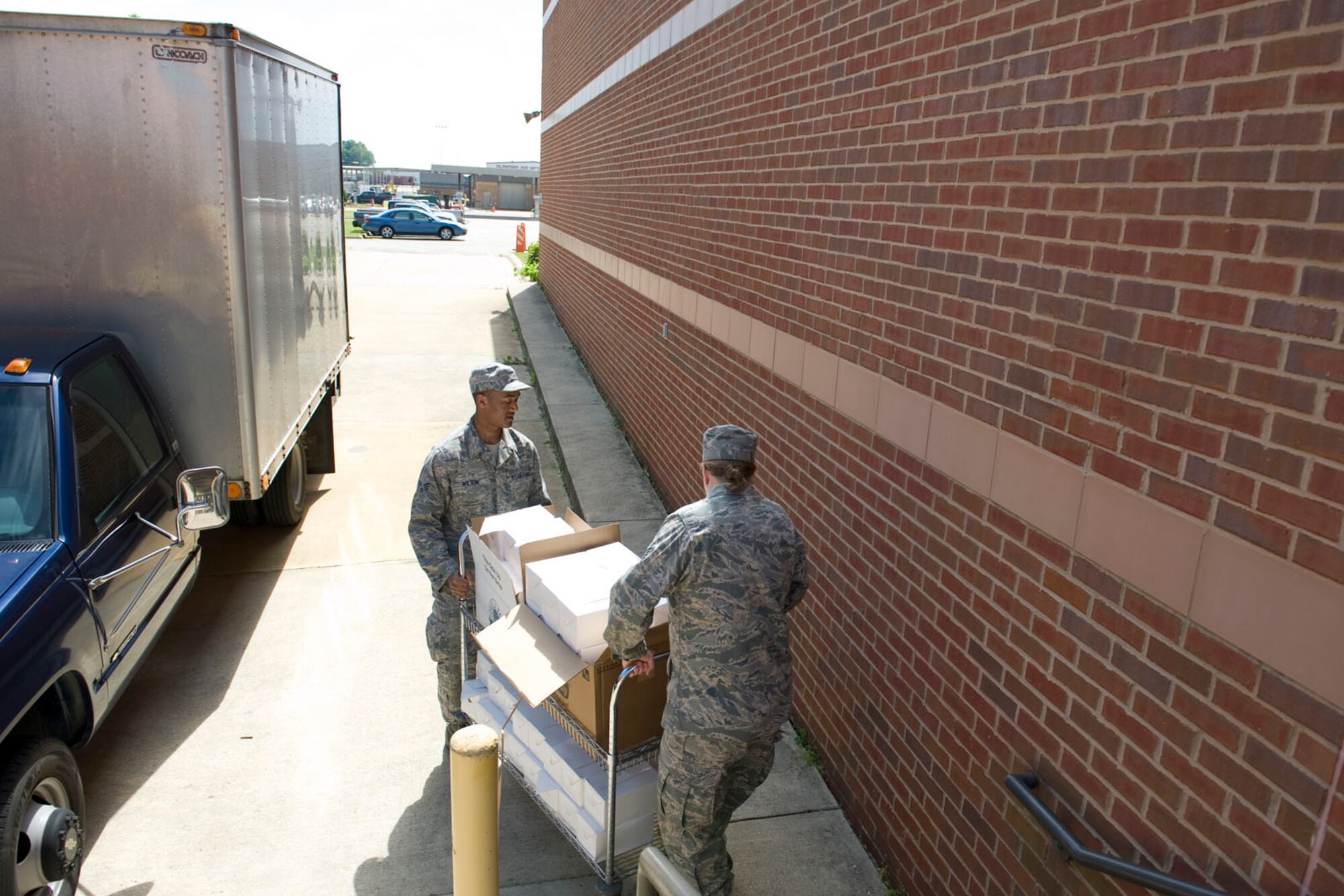 DANNELLY FIELD, Ala. - Senior Airman Allen Wilson and Tech. Sgt. Trisha Willis, services technicians from 176th Sustainment Services Element, Alaska Air National Guard, wheel box lunches to a delivery truck, May 5, 2011. Wilson and Willis were at Danelly Field, Ala. to borrow the kitchen of the 187th Fighter Wing make lunches for a group of deployers who were working out of Hayneville, Ala. There were about 70 deployer from numerous military components and services in Hayneville for an Innovative Readiness Training (IRT) mission. The IRT program allows for real world training opportunities for military personnel while providing needed services to under-served communities in the United States. Alaska Air National Guard photo by Master Sgt. Shannon Oleson.