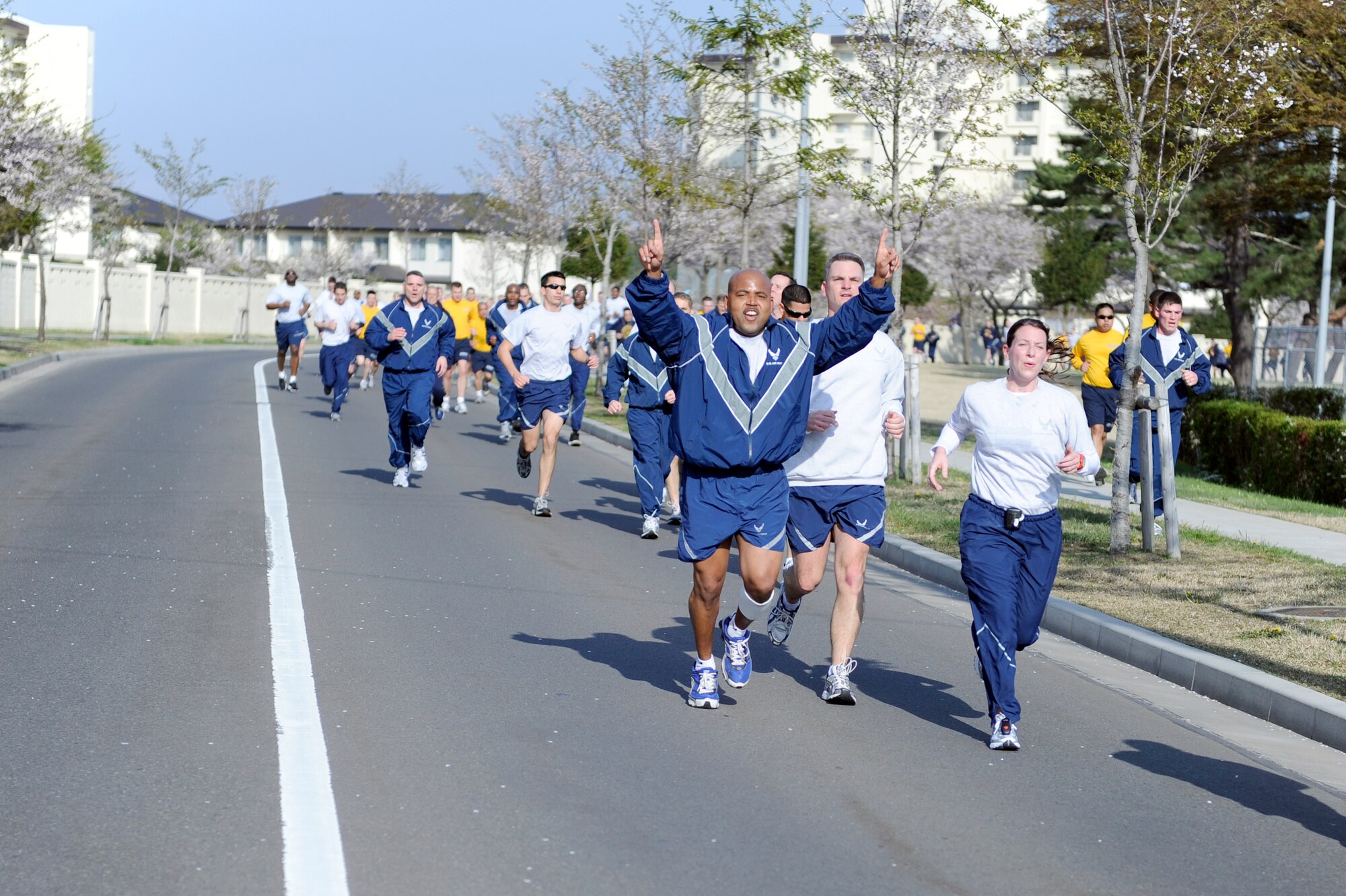 MISAWA AIR BASE, Japan -- Airmen and Sailors make a strong finish during the monthly readiness run May 6. The readiness run is a monthly tradition on the base and is held to promote fitness and raise espirit de corps. (U.S. Air Force photo/Staff Sgt. Marie Brown/Released)