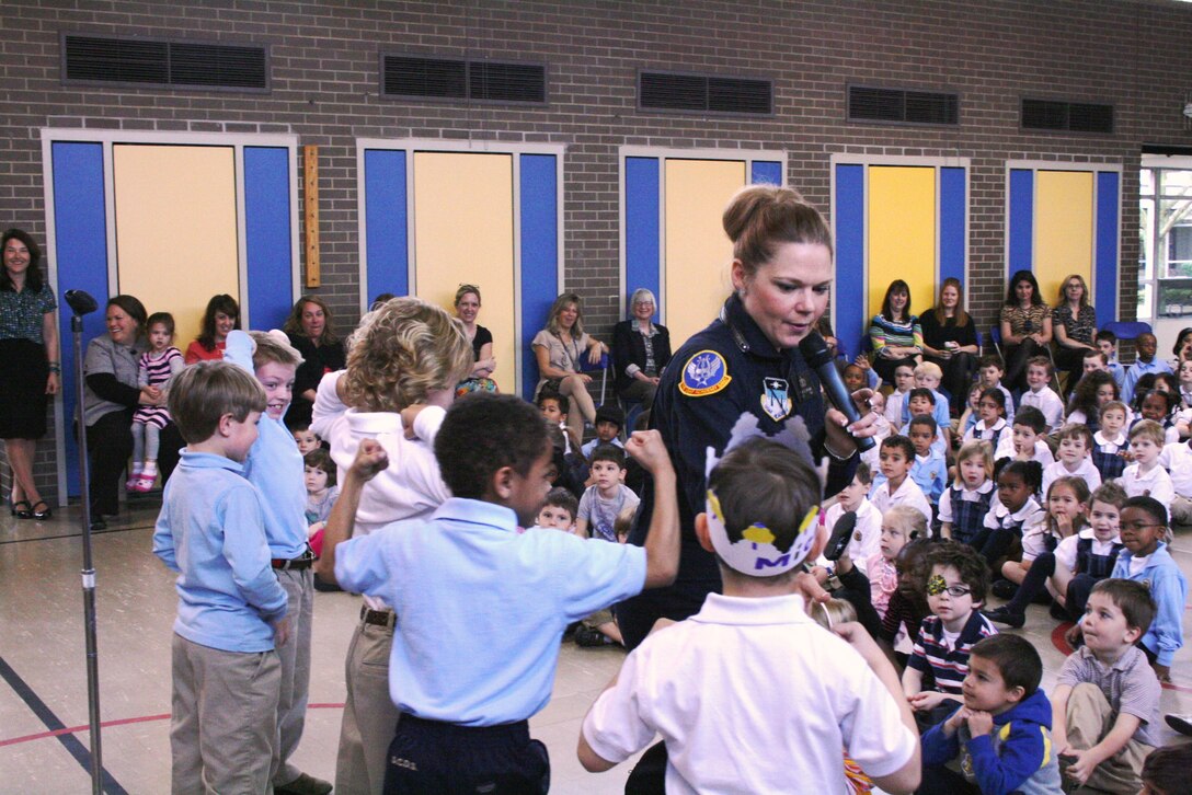 Technical Sergeant Sarah Stewart demonstrates teamwork to students from the Detroit Country Day School in Beverly Hills, Michigan. Education outreach is an important part of the mission of the United States Air Force Academy Band.