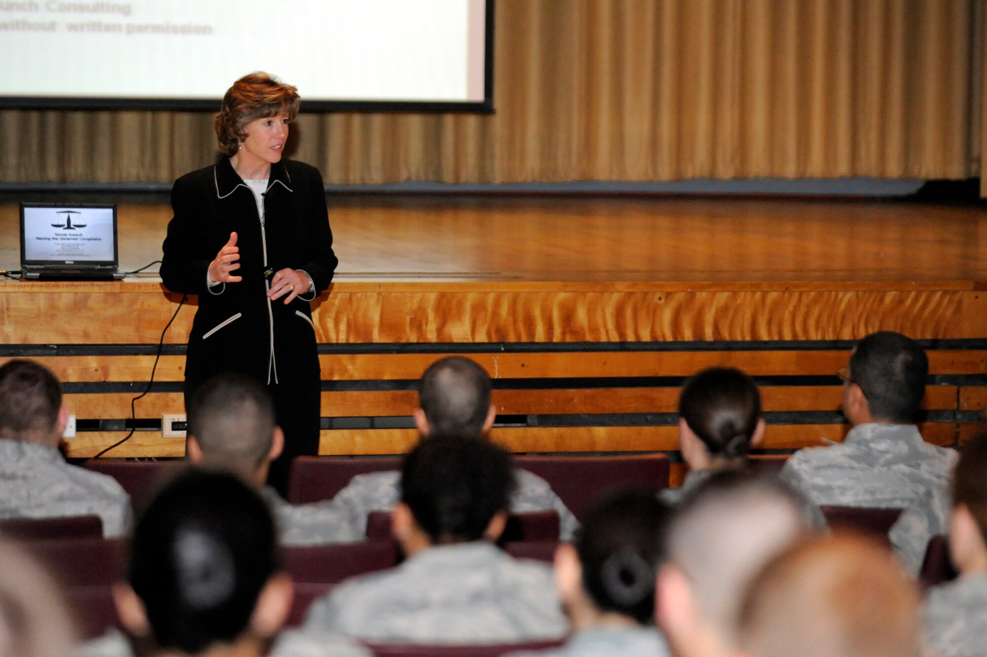 Anne Munch talks to Airmen at a presentation in the Base Theater on April 28 on the influence of the "unnamed conspirator" which becomes a factor in prosecutions, jury selections and influences behaviors. The former prosecuter and now educator on the topic of sexual assault prevention presented compelling information to bring attention to the topic. (U.S. Air Force photo by Todd Cromar)
