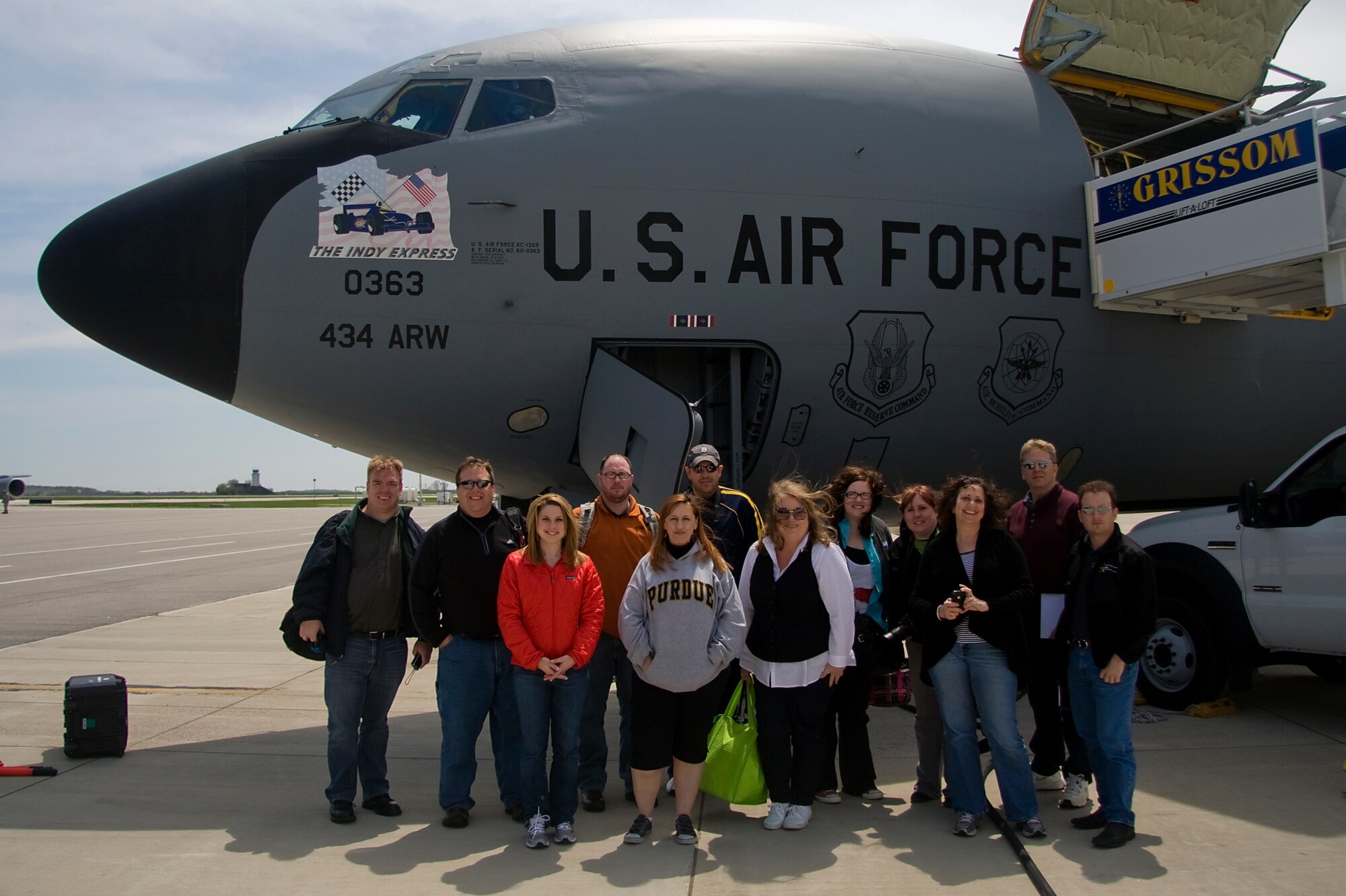 GRISSOM AIR RESERVE BASE, Ind. -- Indiana social media representatives pose for a photo in front of The Indy Express, a KC-135R Stratotanker aircraft they flew on while taking part in media orientation flight May 5. During the flight, the tweeters, bloggers and photographers were able to witness firsthand the aerial refueling mission of the 434th ARW as a crew from the 72nd Air Refueling Squadron refueled a U.S. Navy E-6 from Tinker Air Force Base, Okla. From left to right are Leilan McNally, Dave Woodson, Nicole Misencik, Chad Pollitt, Elizabeth Musgrave, Christopher Theisen, Amy Stark, Jessica Funk, Jenell Orelup,  Lorraine Ball, Jamie Till and Don Costanza,. (U.S. Air Force photo/Tech. Sgt. Mark R. W. Orders-Woempner)
