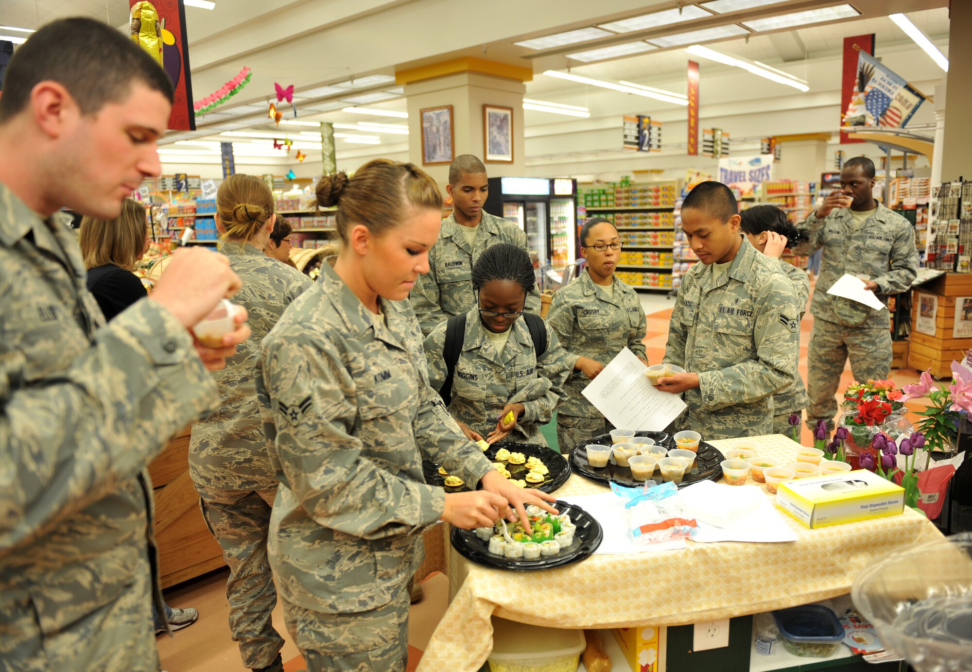 Airmen from Team Scott taste some recipes that are cost efficient to their budget May 5, 2011 at Scott Air Force Base, Ill.  Airmen receiving BAS are taught how to make their money last the entire month. (U.S. Air Force photo/ Airman 1st Class Divine Cox)