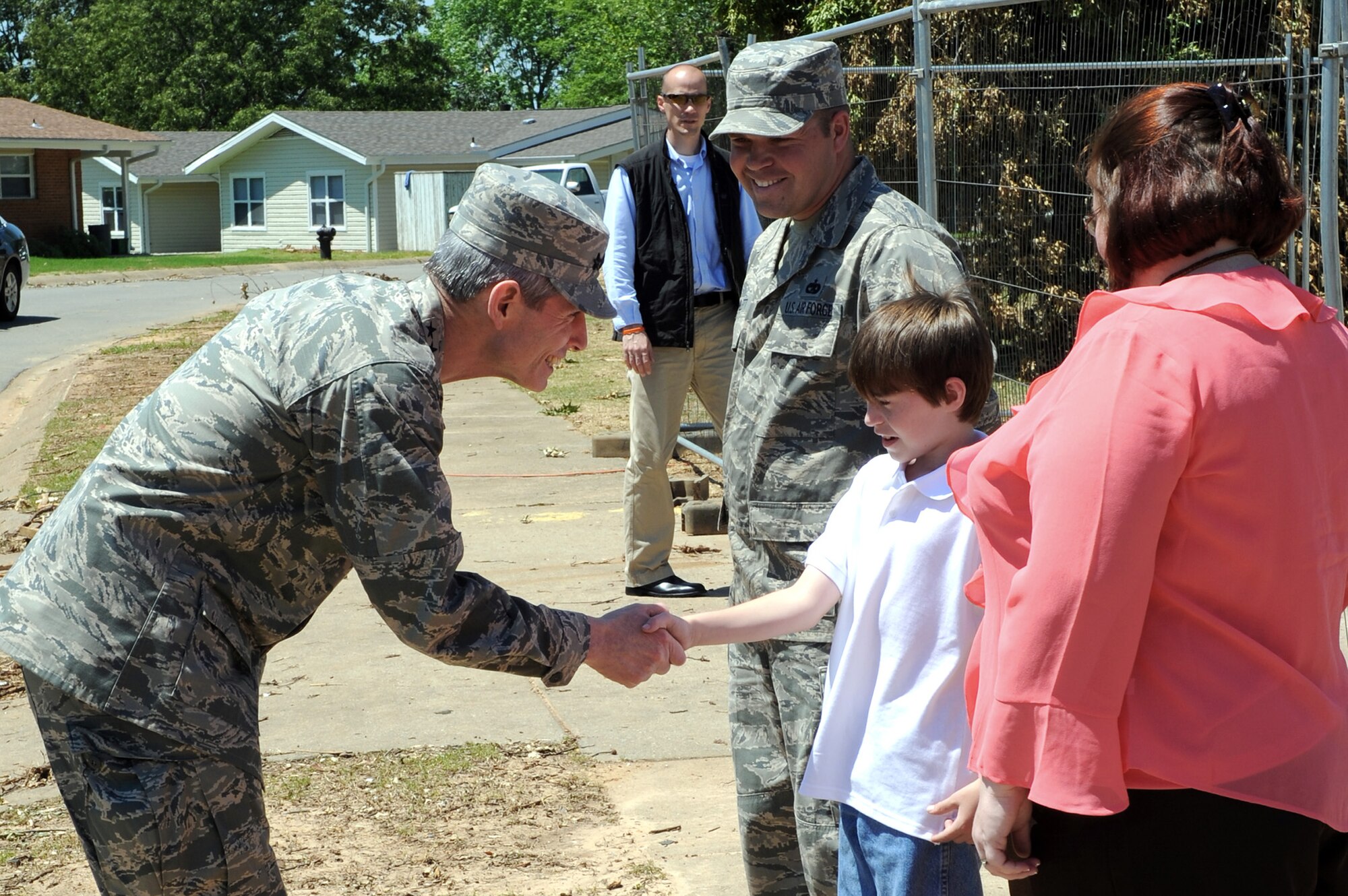 Air Force Chief of Staff Gen. Norton Schwartz shakes hands with Jesse, son of Staff Sgt. Eric Bramblett, May 4, 2011, outside their base house at Little Rock Air Force Base, Ark. Sergeant Bramblett is a vehicle operator and dispatcher assigned to the 19th Logistics Readiness Squadron. He returned from a deployment to Iraq after his house was destroyed by the tornado that hit Little Rock AFB April 25, 2011. (U.S. Air Force photo/Airman 1st Class Rusty Frank)