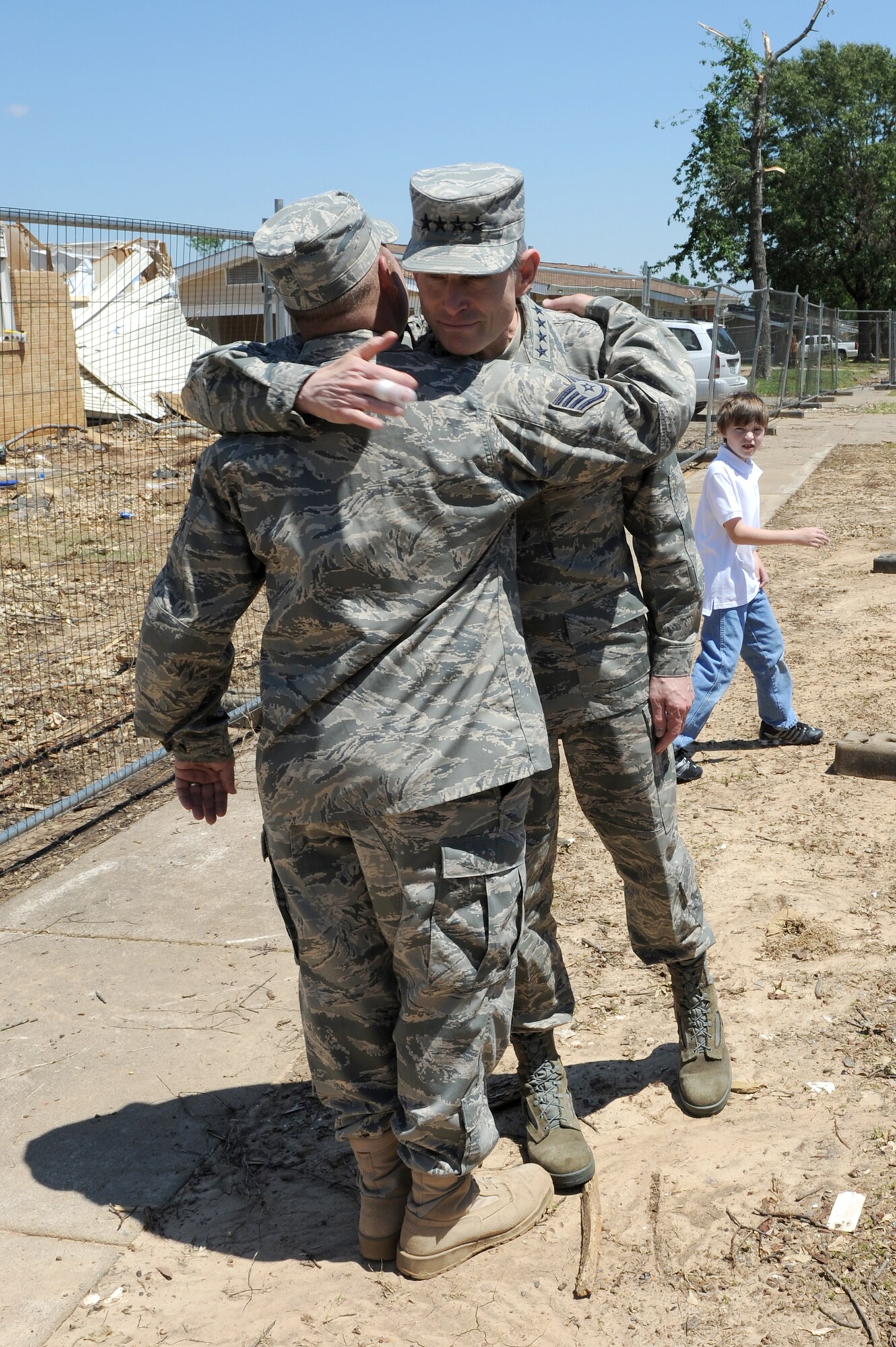 Air Force Chief of Staff Gen. Norton Schwartz hugs Staff Sgt. Eric Bramblett outside his base house May 4, 2011, at Little Rock Air Force Base, Ark. Sergeant Bramblett is a vehicle operator and dispatcher assigned to the 19th Logistics Readiness Squadron. He returned from a deployment to Iraq after his house was destroyed by the tornado that hit Little Rock AFB April 25, 2011. (U.S. Air Force photo/Airman 1st Class Rusty Frank)