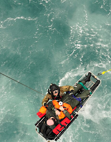 Staff Sgt. Jacob Schaumberg "rescues" 1st Lt. Brandon Rice as part of a joint field exercise April 27, 2011, near Okinawa, Japan. Sergeant Schaumberg is a pararescueman assigned to the 31st Rescue Squadron at Kadena Air Base, Japan. Lieutenant Rice is assigned to the 33rd Rescue Squadron, also at Kadena AB. (U.S. Air Force photo/Staff Sgt. Lakisha A. Croley)
