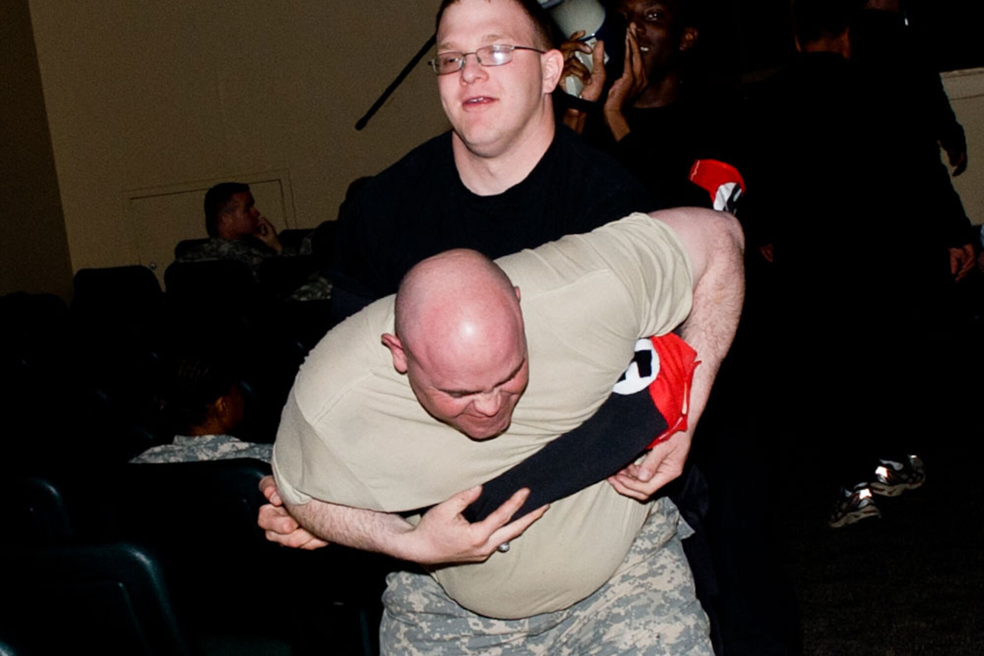 Spc. Christopher Fisher, Headquarters and Headquarters Company, 17th Combat Sustainment Support Battalion (Provisional), playing the part of a Nazi, wrestles Army Staff Sgt. Cody Britton, Forward Support Company, 6th Engineer Battalion, who is playing the part of a Jew during the “Holocaust Days of Remembrance,” held at the Joint Base Elmendorf-Richardson Post Theater May 3.  (U.S. Air Force photo\Johnathon Green)