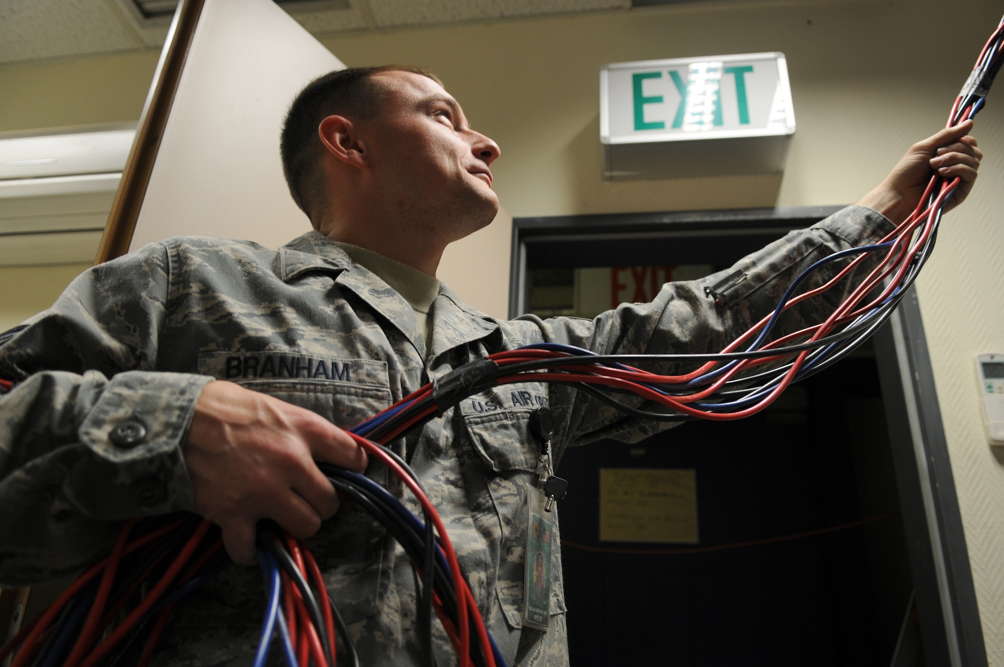 Tech. Sgt. William Branham helps remove network cable as part of a renovation project to the U.S. Air Forces in Europe Warrior Preparation Center in Einsiedlerhof, Germany. The WPC is a training compound for U.S. and coalition forces that provides live, virtual and constructive environments that are seen in downrange. The renovation is aimed at improving network infrastructure and customer service, saving nearly $250,000 annually. Sergeant Branham is a WPC network infrastructure technician. (U.S. Air Force photo/2nd Lt. Christopher Diaz)