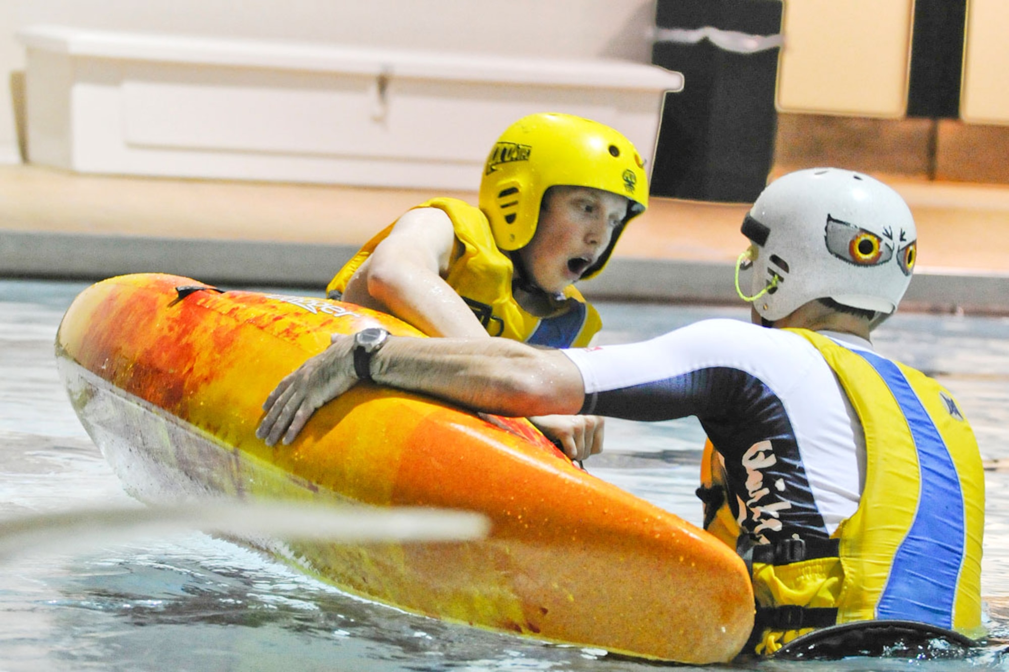 TC Roberts prepares to roll his kayak during kayak training class at the JBER-Elmendorf Fitness Center pool recently. Training is highly recommended for those who want to kayak in Alaska, as while the sport is generally safe, the environment can make it a life-or-death situation. (U.S. Air Force photo by\Steve White)