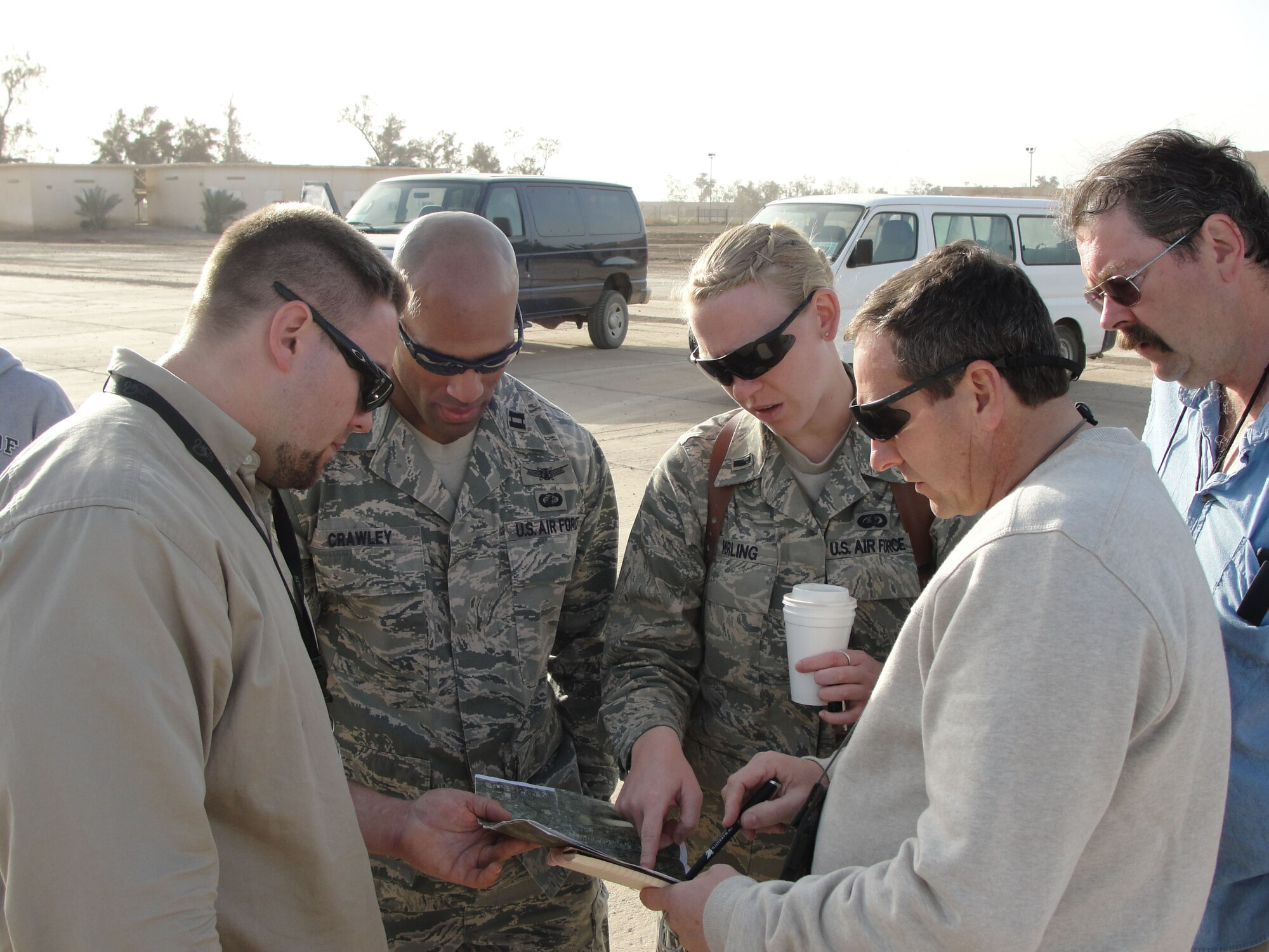 Members of a combined Electronic Systems Center and contractor team, along with an advisor, discuss plans for long-range radars for the Iraqi air force during a visit to the country in March. The team is working to ensure the Iraqi air force will have the capability to  provide its own air defense. Pictured from left is:  Paul Risotti, project manager, Capt. Wesley Crawley, program manager, 1st Lt. Erin Werling, Base Transition Team member and advisor, Steve Burdick, C&S Company construction engineer and Chuck Halse, Lockheed Martin Air C2 technical director. (Courtesy photo)
