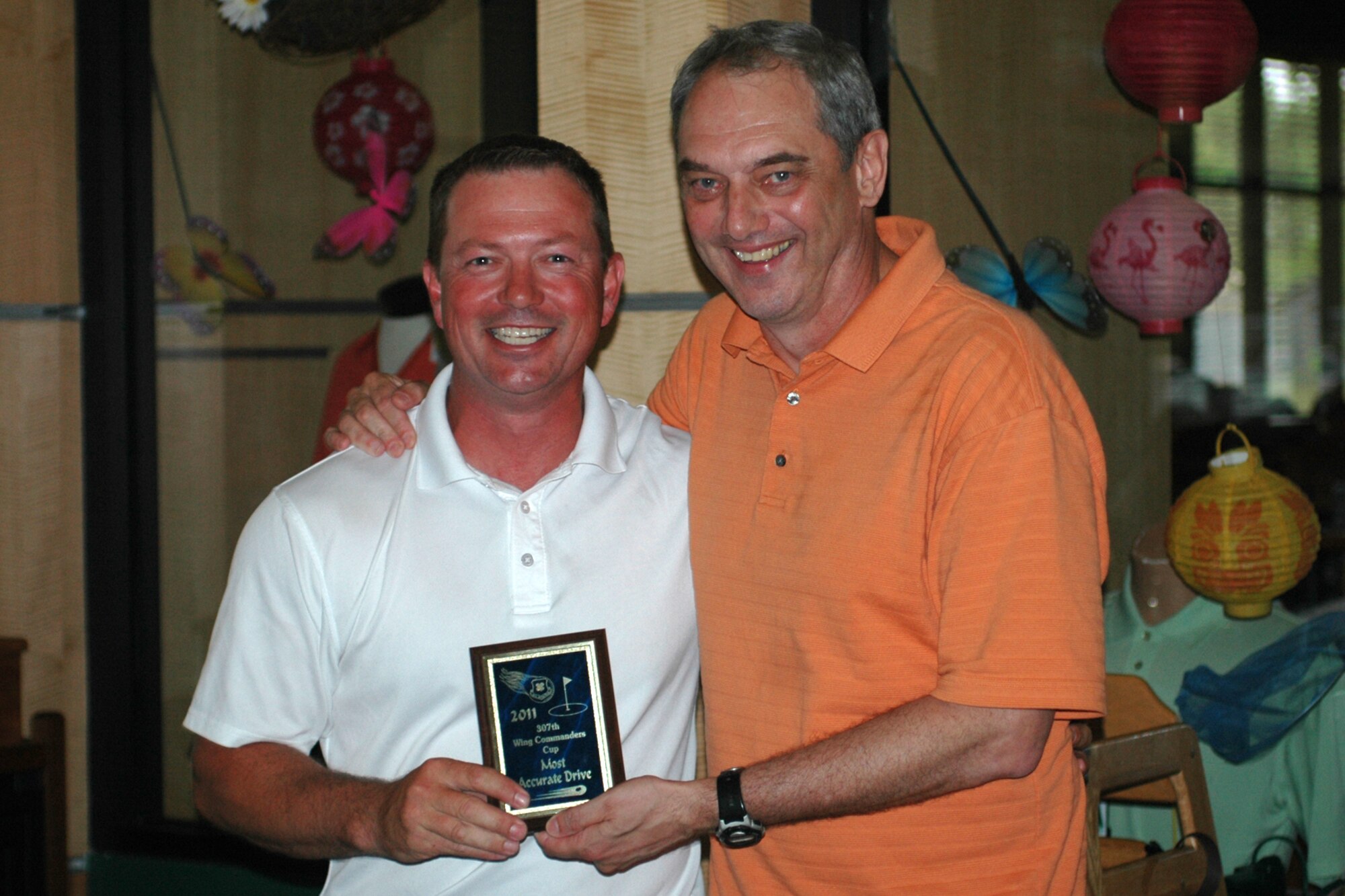 Darren Ellingwood is all smiles as Brig. Gen. John J. Mooney III, the 307th Bomb Wing Commander, presents him with the “Most Accurate Drive” award at the 307th Bomb Wing Commander's Cup Golf Tournament held at Fox Run Golf Course at Barksdale Air Force Base, La., April 30, 2011. The golf tournament, which is combined with a family day picnic, is used by the 307th BW commander to bring family members of 307th BW Airmen together to get to know each other as one big Air Force family. (U.S. Air Force photo/Staff Sgt. Ted Daigle)