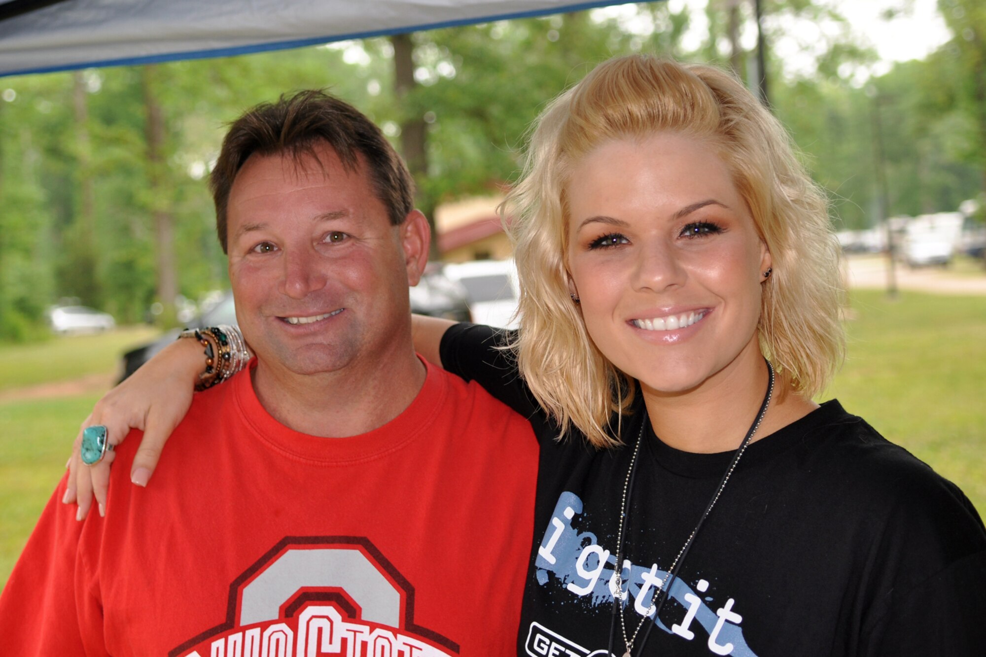 Keith Castleberry takes a moment to pose with recording artist and American Idol contestant Kimberly Caldwell at the 307th Bomb Wing’s Family Day at Cullen Park on Barksdale Air Force Base, La., April 30, 2011. The family day picnic, which is combined with a golf tournament, is used by the 307th BW commander to bring family members of 307th BW Airmen together to get to know each other as one big Air Force family.  (U.S. Air Force photo/Betty Stephens)