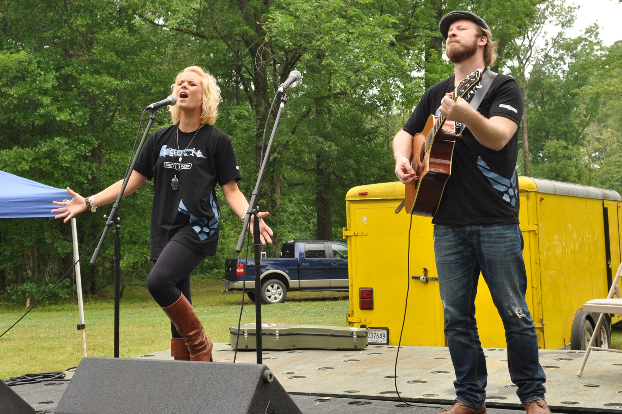 Recording artist and American Idol contestant Kimberly Caldwell performs with guitarist Michael Chaves for a large crowd at the 307th Bomb Wing’s Family Day at Cullen Park on Barksdale Air Force Base, La., April 30, 2011. The family day picnic, which is combined with a golf tournament, is used by the 307th BW commander to bring family members of 307th BW Airmen together to get to know each other as one big Air Force family.  (U.S. Air Force photo/Betty Stephens)