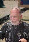 Frank Lawrence, Defense Language Institute English Language Center, gets splashed by a water balloon during the AMIGO picnic April 29 at Stillman Park. The American Members of International Goodwill to Others sponsorship program pairs DLI students with American active-duty military members and civilians to make students feel welcome while acquainting them with American society and customes. (U.S. Air Force photo/Robbin Cresswell)