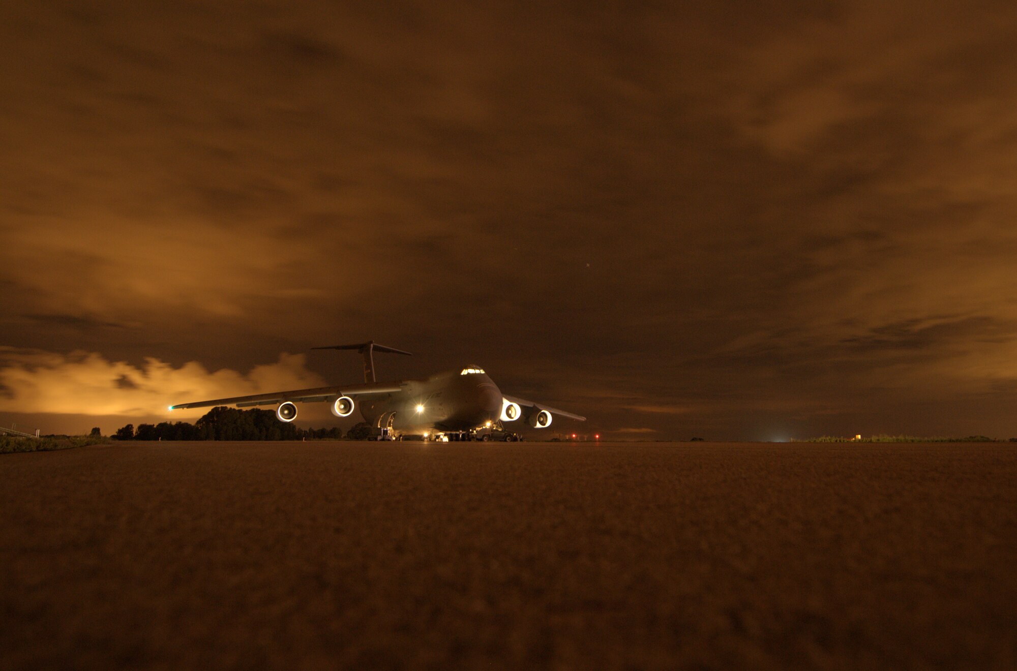 WRIGHT-PATTERSON AIR FORCE BASE, Ohio – The night sky in Spain casts an eerie glow across a 445th Airlift Wing C-5 Galaxy sitting on the ramp during a stopover at Rota Naval Air Station, Spain, April 23. (U.S. Air Force photo/Senior Master Sgt. Michael Kalbfleisch)