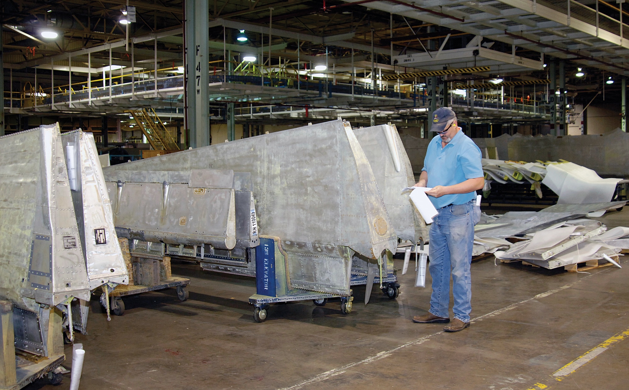 John Snow, a 551st Commodities Maintenance Squadron Wash/Strip work leader, is surrounded in their Bldg. 9001 shop by aircraft parts cleaned and ready for the customer.  The rows of clean parts are a visual victory for the 551st that recently was buried in backlog and saddled with a lower morale.  The outcome of a Rapid Improvement Event brought changes, a better work flow and a brighter outlook of the workforce.  (Air Force photo by Margo Wright)