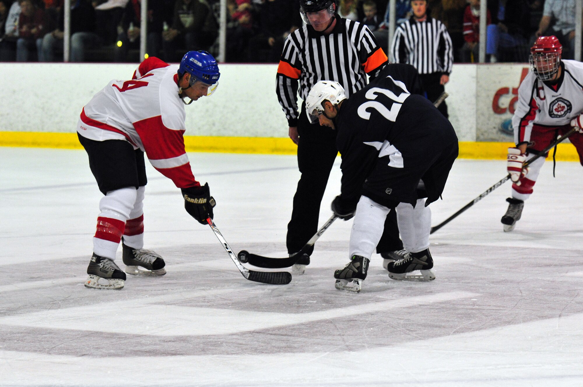 Canadian player Kyle Bostic, left, faces off against Derrick Iwanenko after the Americans scored to cut the Canadian lead in half during the 2011 CAN/AM Cup. The American Component of the 552nd Air Control Wing skated home with a 6-3 victory in the third annual contest, which was played April 29 at the Blazers Ice Center in south Oklahoma City. (Courtesy photos)

