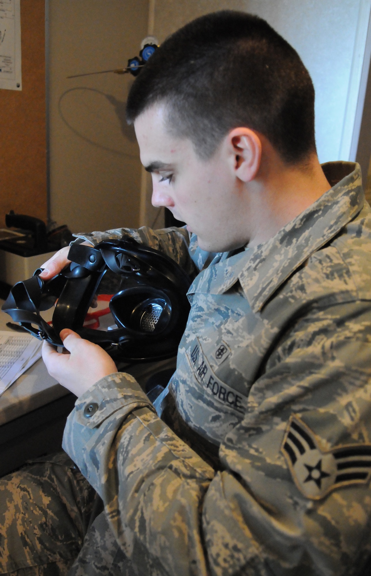 Senior Airman Samuel Bergh inspects a full face mask for defects during a routine inspection April 25, 2011, Eielson Air Force Base, Alaska. Bioenvironmental engineer Airmen conduct inspections of equipment routinely to ensure each piece of equipment performs to Air Force standards. Airman Bergh is assigned to the 354th Medical Operations Squadron Bioenvironmental Engineering section. (U.S. Air Force photo/Senior Airman Rachelle Coleman)