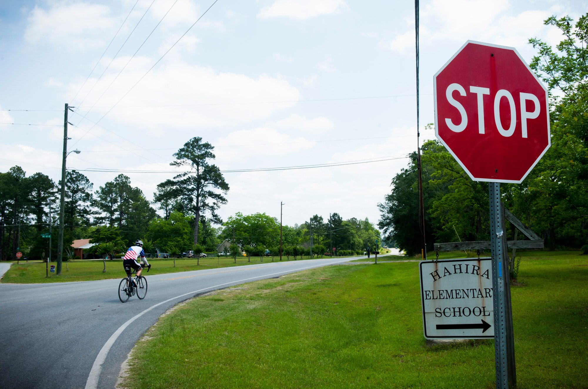 HAHIRA, Ga.-- Jason Rogers, Air Force veteran , rides his bicycle along highway road 122 to the town of Waycross, Ga. on his journey across the United States May 2. Mr. Rogers traveled across the U.S. to raise money for the Wounded Warrior program. (U.S. Air Force photo/Airman 1st Class Benjamin Wiseman)(RELEASED)