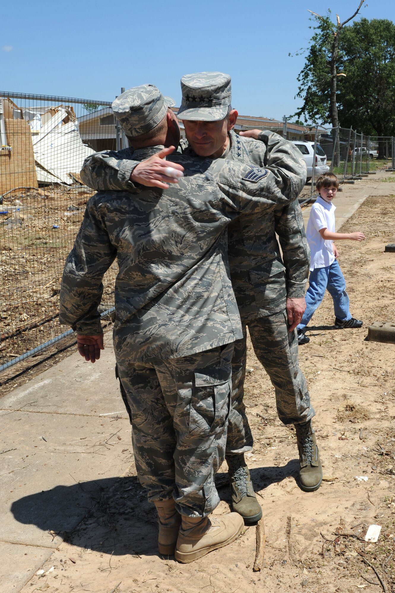 Air Force Chief of Staff Gen. Norton Schwartz hugs Staff Sgt. Eric Bramblett outside his base house May 4, 2011, at Little Rock Air Force Base, Ark., during a base visit. Sergeant Bramblett, a 19th Logistics Readiness Squadron vehicle operator and dispatcher, returned from a deployment to Iraq after his house was destroyed by the tornado that hit Little Rock AFB April 25, 2011. (U.S. Air Force photo/Airman 1st Class Rusty Frank)