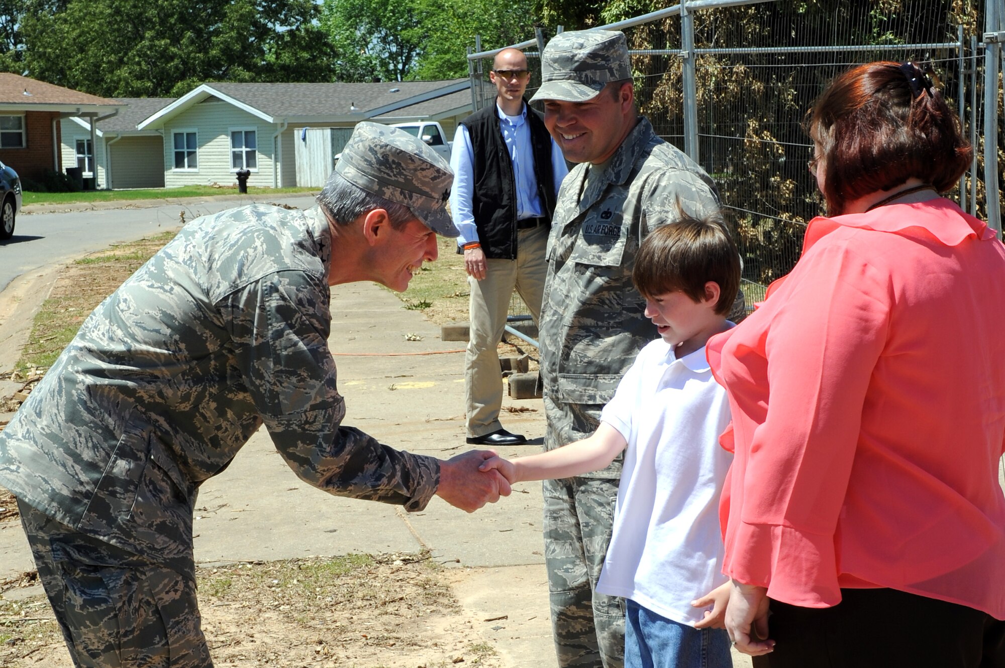 Air Force Chief of Staff Gen. Norton Schwartz shakes hands with Jesse, son of Staff Sgt. Eric Bramblett, outside their base house May 4, 2011, at Little Rock Air Force Base, Ark., during a base visit. Sergeant Bramblett, a 19th Logistics Readiness Squadron vehicle operator and dispatcher, returned from a deployment to Iraq after his house was destroyed by the tornado that hit Little Rock Air Force Base April 25. (U.S. Air Force photo/Airman 1st Class Rusty Frank)