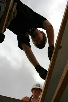 Tech Sgt. Jennifer Brewer and Col. David Slade, Air Force Personnel Center assignments directorate, help roof a house during the April 30 Habitat for Humanity volunteer project.