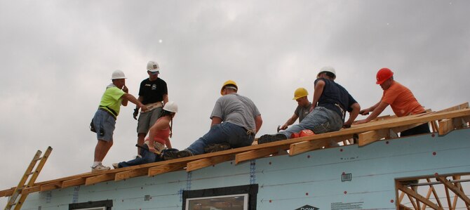 Habitat for Humanity representative Charles Prock (far left) explains roofing safety procedures to Air Force Personnel Center assignments directorate volunteers (left to right) Col. David Slade, Tech. Sgt. Jennifer Brewer, Maj. James Norman, Capt. Jeff Elliott, Maj. Nathan Hippe and Capt. Michael Markley during an April 30 project.