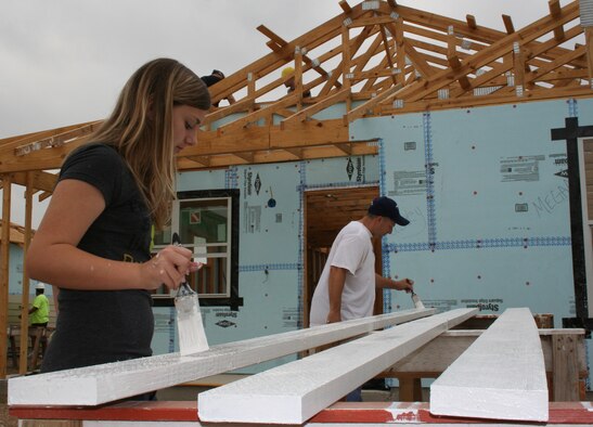 CMSgt  Les Kucksdorf, Air Force Personnel Center assignments directorate, and his daughter Jordan do some painting during the April 30 Habitat for Humanity volunteer project.