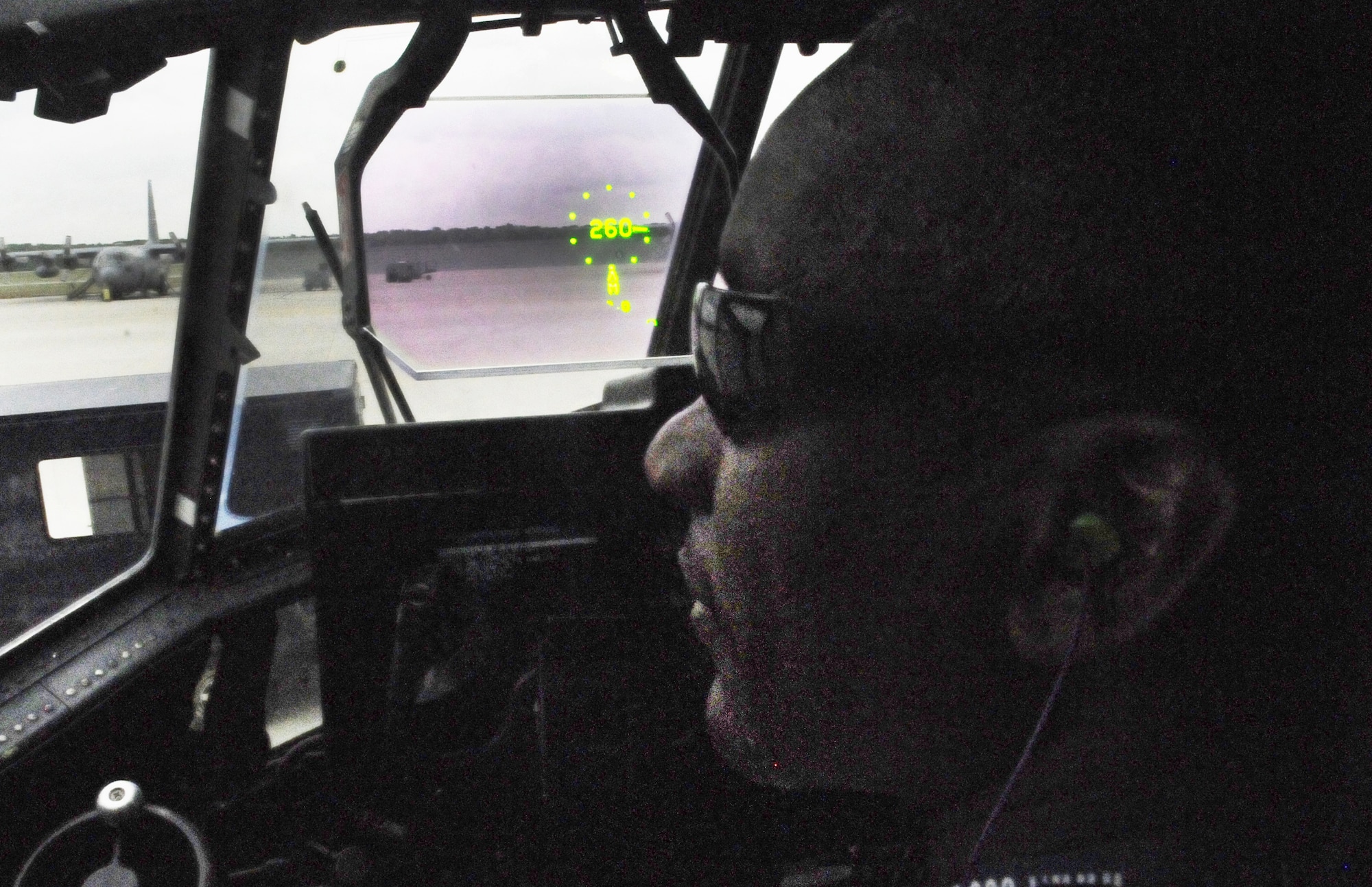 Andre Tucker, 560th AMXS C-130 aircraft overhaul supervisor, shows the heads up display in the C-130J cockpit. U. S. Air Force photo by Sue Sapp