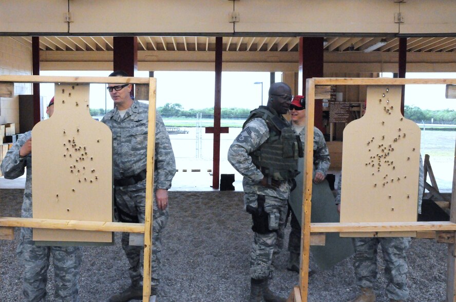 LAUGHLIN AIR FORCE BASE, Texas – Colonel Craig Wills, 47th Operations Group commander, and Chief Master Sgt. Michael King, 47th Mission Support Group command chief, participate in a weapon qualifications course held at Laughlin’s firing range May 4. (U.S. Air Force photo by Senior Airman Scott Saldukas)