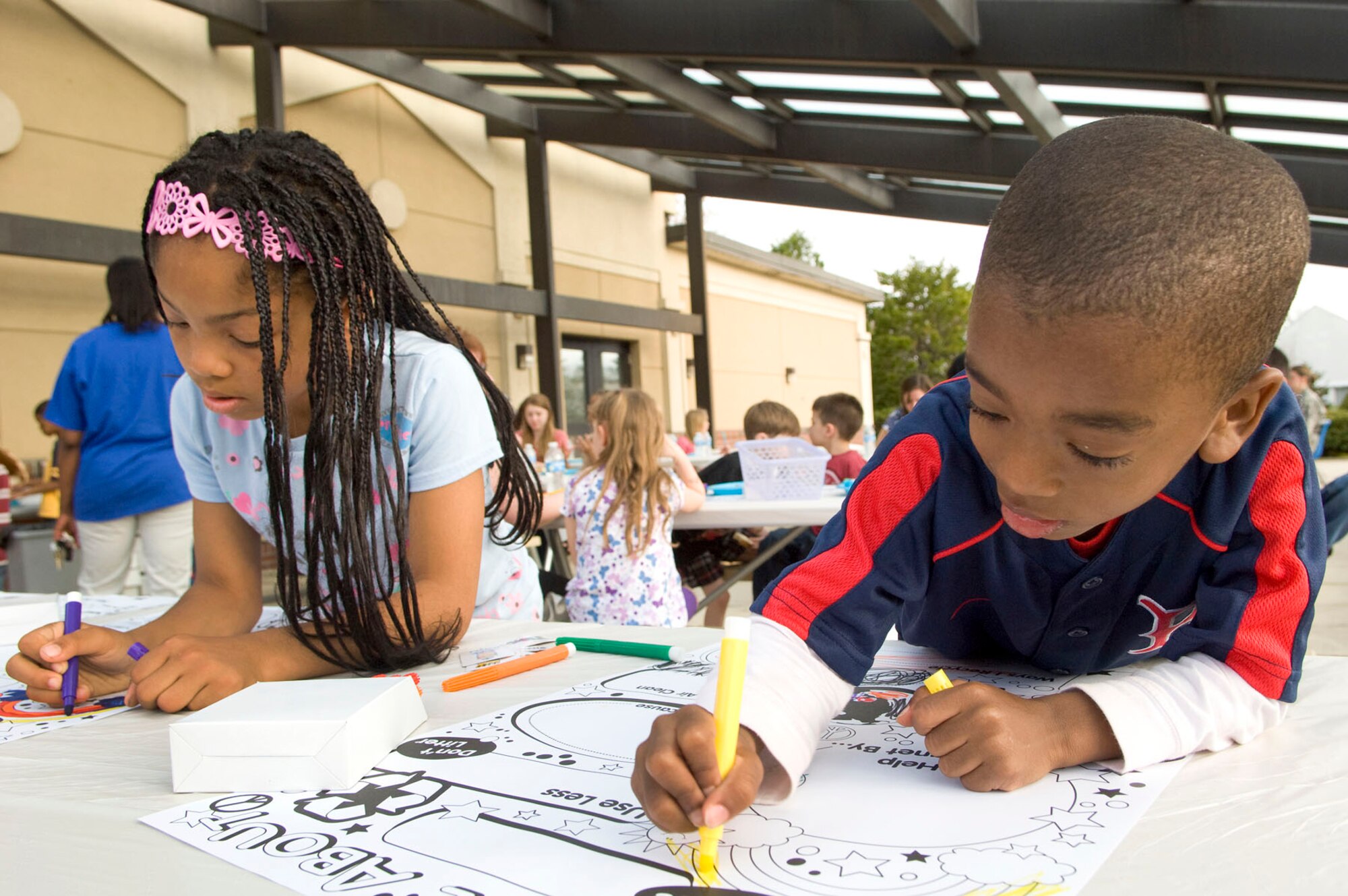 HANSCOM AIR FORCE BASE, Mass. - Jackson Cherry (right) colors a picture while his sister, Ella, works on her own at the Hearts Apart Spring Fling at the Hanscom Library April 27. The event, hosted by the Airmen and Family Readiness Center, was held for families of deployed military personnel. (U.S. Air Force photo by Mark Wyatt)