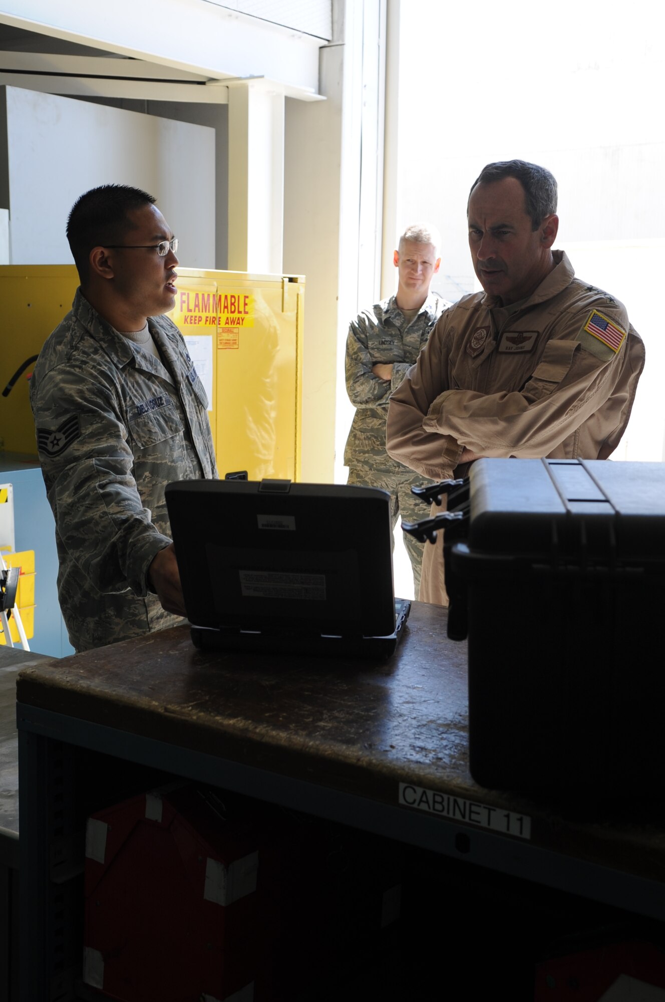 Staff Sgt. Daniel Dela Cruz, from the 728th Air Mobility Squadron, briefs Gen. Raymond E. Johns Jr., the commander of Air Mobility Command, on the new equipment at the 728th AMS March 26, 2011, at Incirlik Air Base, Turkey. General Johns visited the base to learn more about how AMC Airmen are supporting the U.S. Air Forces in Europe mission.  Also pictured is Lt. Col. Brian Lindsey, the 728th AMS commander. (U.S. Air Force photo by Airman 1st Class Clayton Lenhardt)