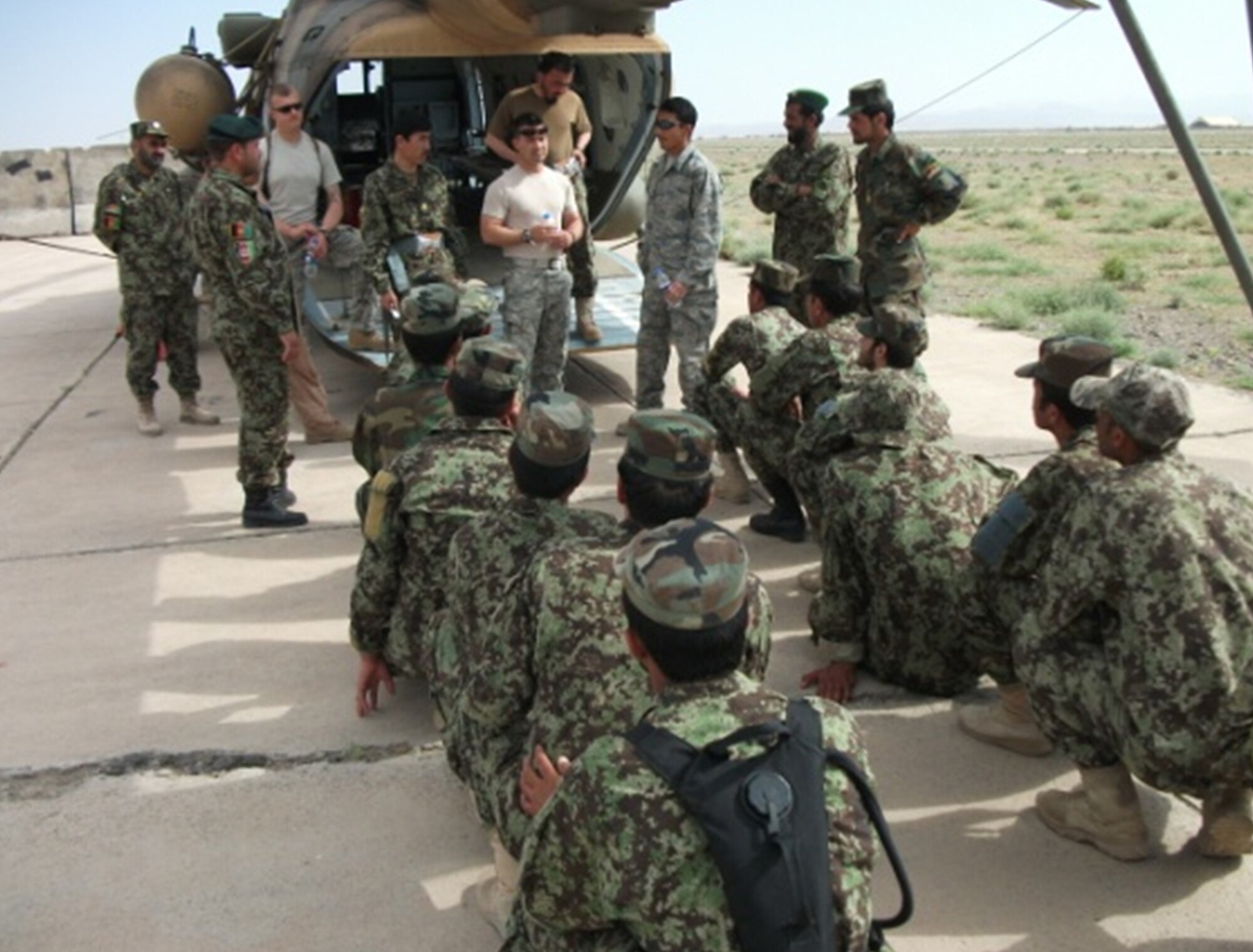 U.S. Air Force advisors conduct pre-brief ground instructions for Afghan National Army soldiers in local training at Kabul. Seven Afghan Mi-17 instructors graduated May 4 from the first Mi-17 "Train the Trainer" upgrade course taught by AAF and U.S. Air Force instructors at the Afghanistan Premier Flight Training Center. (U.S. Air Force courtesy photo). 

