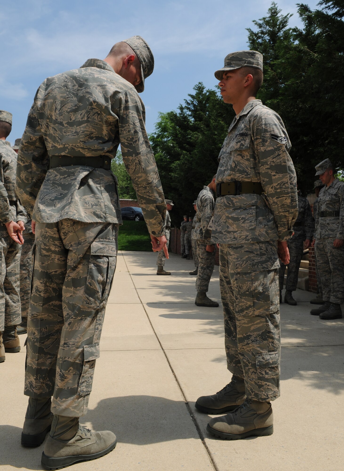 Airman Alex Bruner, U.S. Air Force Honor Guard trainee, advises Airman 1st Class Christopher Newlands, fellow trainee, on the proper stance for parade-rest May 3 at Joint Base Anacostia-Bolling, Washington, D.C. During the eight-week course, Airmen will learn advanced drill and ceremony techniques before being assigned to an Honor Guard element. (U.S. Air Force photos by Senior Airman Christopher Ruano)
