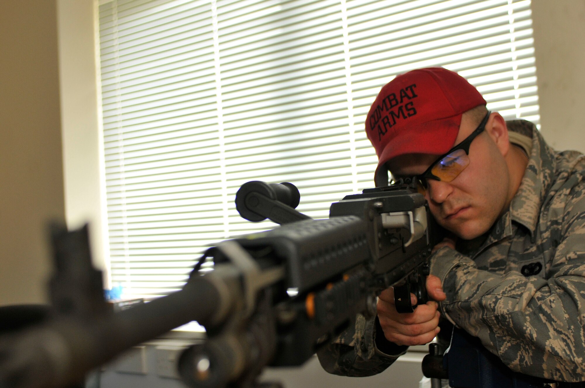 Senior Airman Anthony Komara, 48th Security Forces Squadron Combat Arms instructor, inspects a M240 Bravo machine gun at the Combet Arms Training and Maintenance facility on May 5, 2011. Airman Komara was nominated for a Liberty Spottlight because he displays the core value of 'Service Before Self'. (U.S. Air Force photo/Senior Airman Eboni Reams)