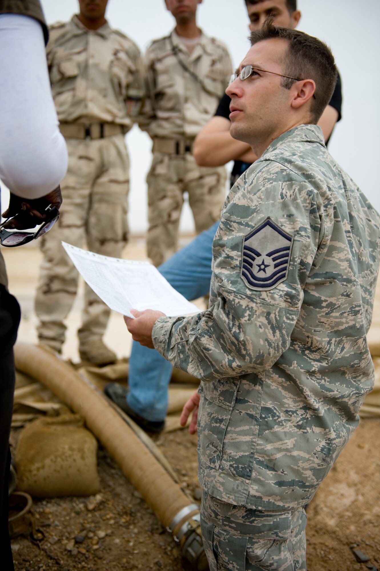 ALI AIR BASE, Iraq -- Master Sgt. Ron Crowl, 407th Expeditionary Support Squadron petroleum, oils and lubricants flight superintendent, discusses how to maintain a fuel storage area with Iraqi military members April 22. The POL flight taught the Iraqis how to properly maintain their fuel area in order to prevent and minimize fuel spills. Sergeant Crowl is deployed from Elmendorf Air Force Base, Alaska, and is a native of Anchorage, Alaska. (U.S. Air Force photo by Staff Sgt. Levi Riendeau)
