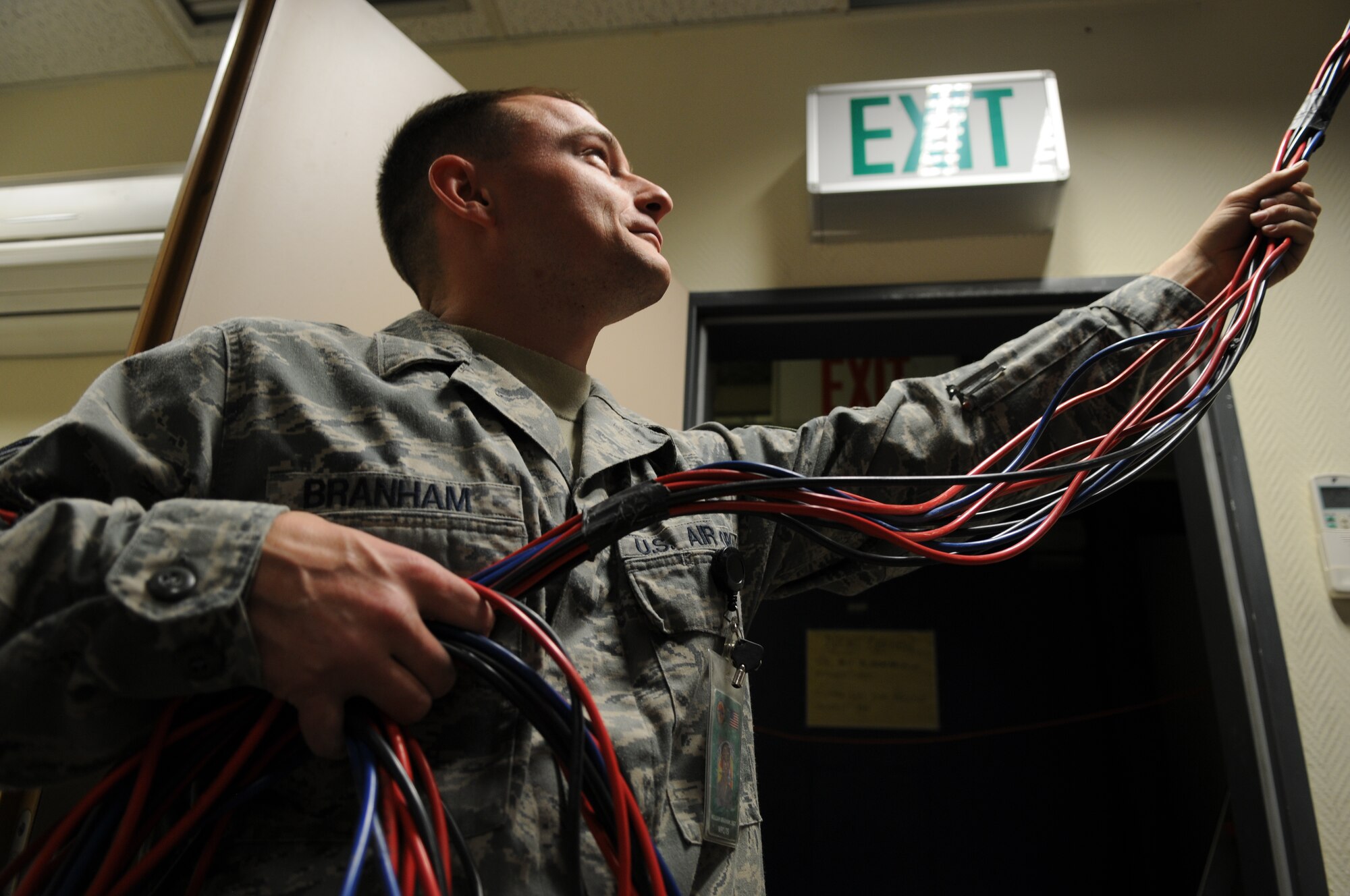 Tech. Sgt. William Branham, Warrior Preparation Center network infrastructure technician, helps remove network cable as part of a renovation project to the WPC. The WPC is a training compound for U.S. and coalition forces that provides live, virtual and constructive environments that are seen in downrange. The renovation is aimed at improving its network infrastructure and customer service, saving nearly a quarter of a million dollars annually thus far. (U.S. Air Force photo by 2nd Lt. Christopher Diaz) 
