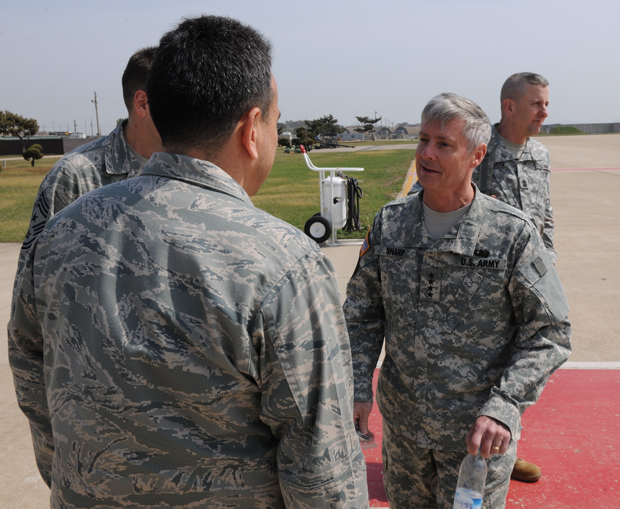 KUNSAN AIR BASE, Republic of Korea -- Gen. Walter Sharp, commander, United Nations Command, Combined Forces Command, U.S. Forces Korea, is greeted by Col. Hugh Hanlon, 8th Fighter Wing vice commander, as he arrives for a visit to the Wolf Pack here May 4. The focus of his visit was to present Kunsan’s Pacific Air Forces operational readiness inspection outstanding performers with his personal coin and extend words of gratitude and appreciation for a job well done on the 8th FW’s ‘Excellent’ rating. (U.S. Air Force photo/Senior Airman Brittany Bateman)