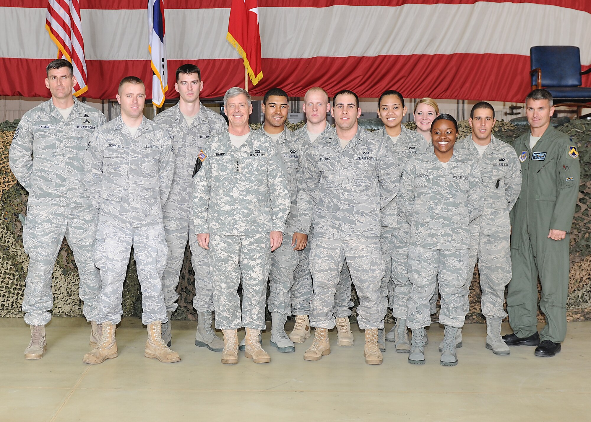 KUNSAN AIR BASE, Republic of Korea  -- Gen. Walter Sharp, commander, United Nations Command, Combined Forces Command, U.S. Forces Korea, recognizes and takes a group photo with the outstanding performers from the 2011 Pacific Air Forces operational readiness inspection during a coin ceremony here May 4. The general presented Airmen with his personal coin and praised the wing for the “Excellent” rating garnered during the inspection. (U.S. Air Force photo/Senior Airman Brittany Bateman)