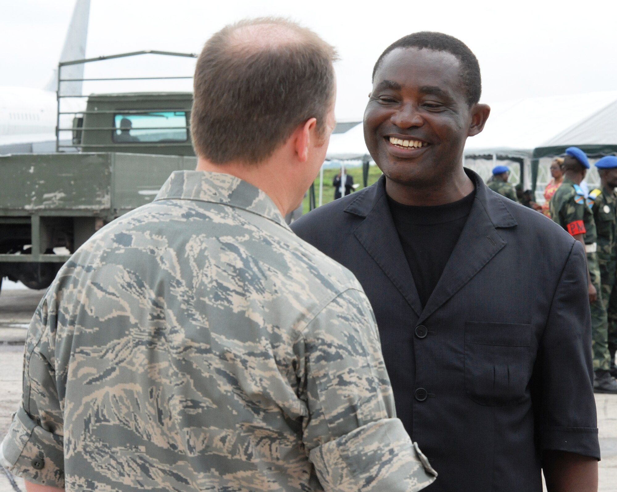 KINSHASA, Democratic Republic of the Congo -- Yulu Kabamba Alphonse, a free lance translator for the Democratic Republic of the Congo, speaks with Lt. Col. Matt Peterson, a MEDLITE 11 organizer, at the Kinshasa airpot, May 4, 2011. Yulu has been translating medical powerpoint slides for the MEDLITE 11 exercise for the last two weeks and has shown a great desire in the American spirit. MEDLITE 11 is a joint medical exercise focused on aeromedical evacuation, to improve the readiness of U.S. Air Force and DRC personnel. (U.S. Air Force photo by Tech. Sgt. Todd Wivell)