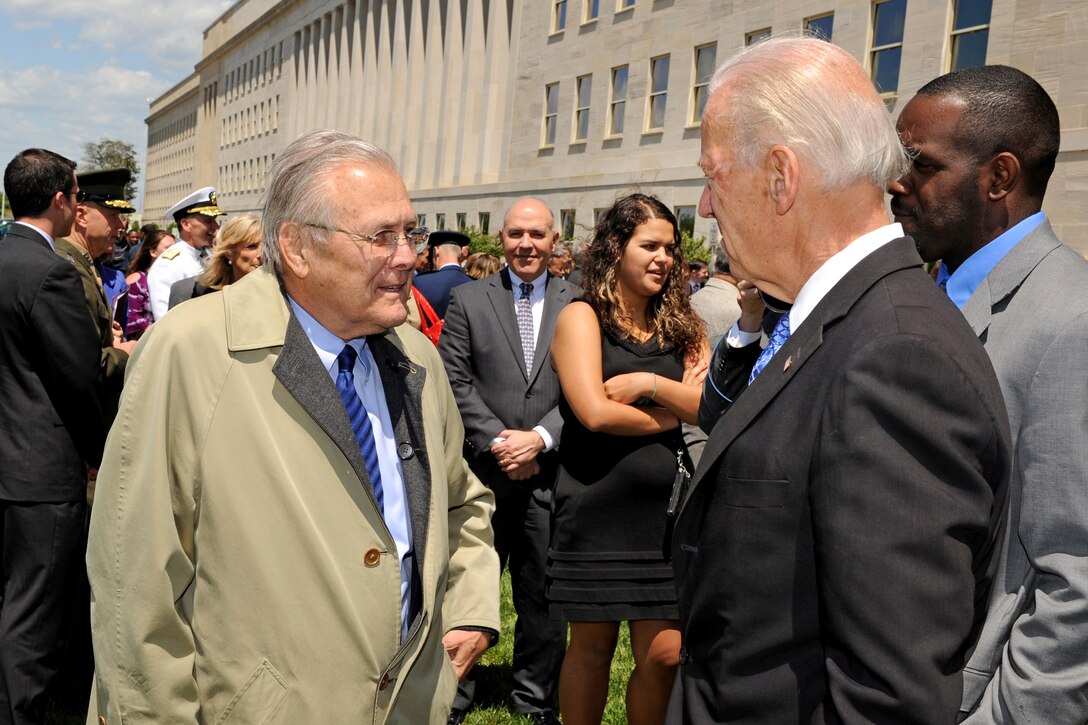 Former Defense Secretary Donald H. Rumsfeld, left, talks with Vice President Joe Biden, right, after a memorial wreath laying ceremony at the Pentagon Memorial May 5, 2011, in honor of the victims of the 9/11 terrorist attack. Rumsfeld was the secretary of defense at the time of the attack and helped carry wounded employees to safety that day. 