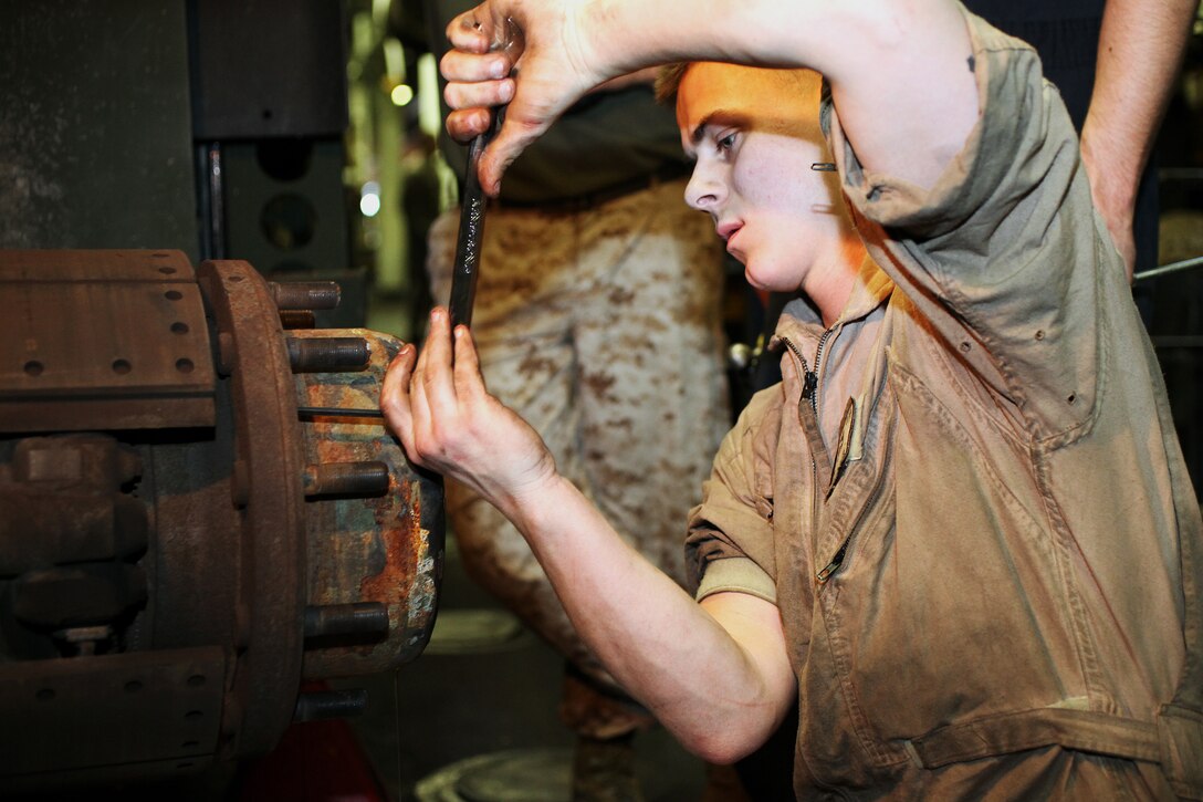 Corporal Mykel C. Foland, 21, a motor transport mechanic with maintenance platoon, Combat Logistics Battalion 22, 22nd Marine Expeditionary Unit, and Schoharie, N.Y., native, disassembles a 7-ton truck’s wheel components for corrective maintenance aboard USS Bataan, May 5, 2011.  The Marines and sailors of the 22nd MEU are currently deployed with Amphibious Squadron 6 aboard USS Bataan Amphibious Ready Group and will continue to train and improve the MEU’s ability to operate as a cohesive and effective Marine Air Ground Task Force.  The 22nd MEU is a multi-mission, capable force comprised of an Aviation Combat Element, Marine Tilt Rotor Squadron 263 (Reinforced); a Logistics Combat Element, CLB 22; a Ground Combat Element, Battalion Landing Team, 2nd Battalion, 2nd Marine Regiment; and its Command Element.