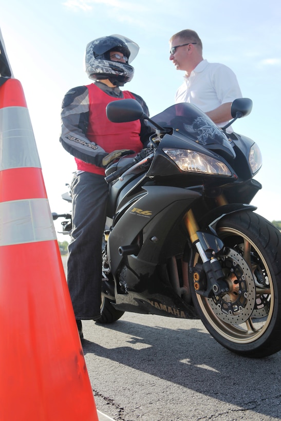 Marine Corps Auxiliary Landing Fields Bogue Field, N.C. – A motorcycle gets tips from John Abney, a safety instructor with the traffic safety department aboard Marine Corps Base Camp Lejeune, during the Motorcycle Rodeo aboard Marine Corps Auxiliary Landing Fields Bogue Field, May 6. The course tested drivers’ skills with stops, turns, and cloverleaf turns.