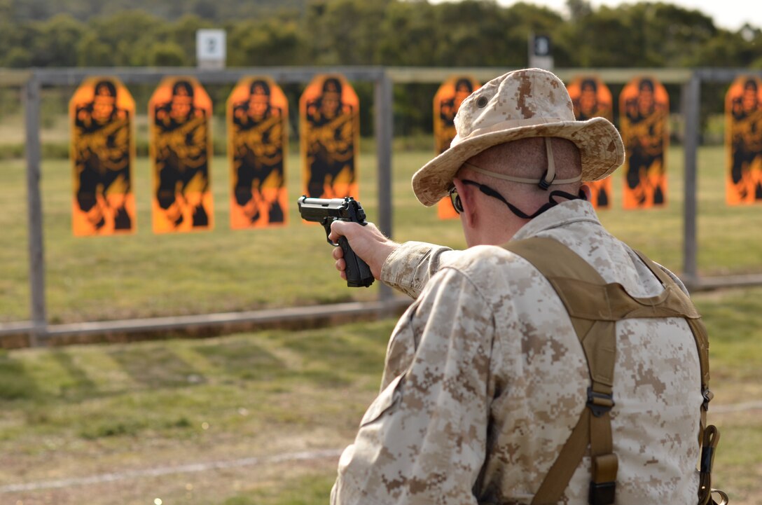 Sgt. Matthew Gullette, competitor, Combat Shooting Team, Weapons Training Battalion, Marine Corps Base Quantico, executes a course of fire at the pistol range here May 7 during the 2011 Australian Army Skill at Arms Meeting.  The meeting is an annual international combat-marksmanship competition hosted by the Australian Army.  (U.S. Marine Corps Photo by Lance Cpl. Mark W. Stroud)
