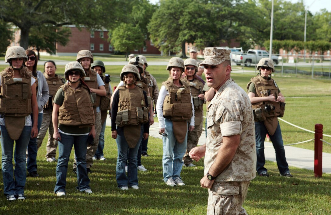 Lt. Col. Ralph J. Rizzo Jr., commanding officer for Combat Logistics Battalion 6, Combat Logistics Regiment 2, 2nd Marine Logistics Group, speaks to spouses during Jane Wayne Day aboard Camp Lejeune, N.C, May 6, 2011. They participated in Marine Corps Martial Arts Program training, learned about weapons systems and shot simulated scenarios at the Indoor Simulated Marksman Trainer. (U.S. Marine Corps photo by Pfc. Franklin E. Mercado)