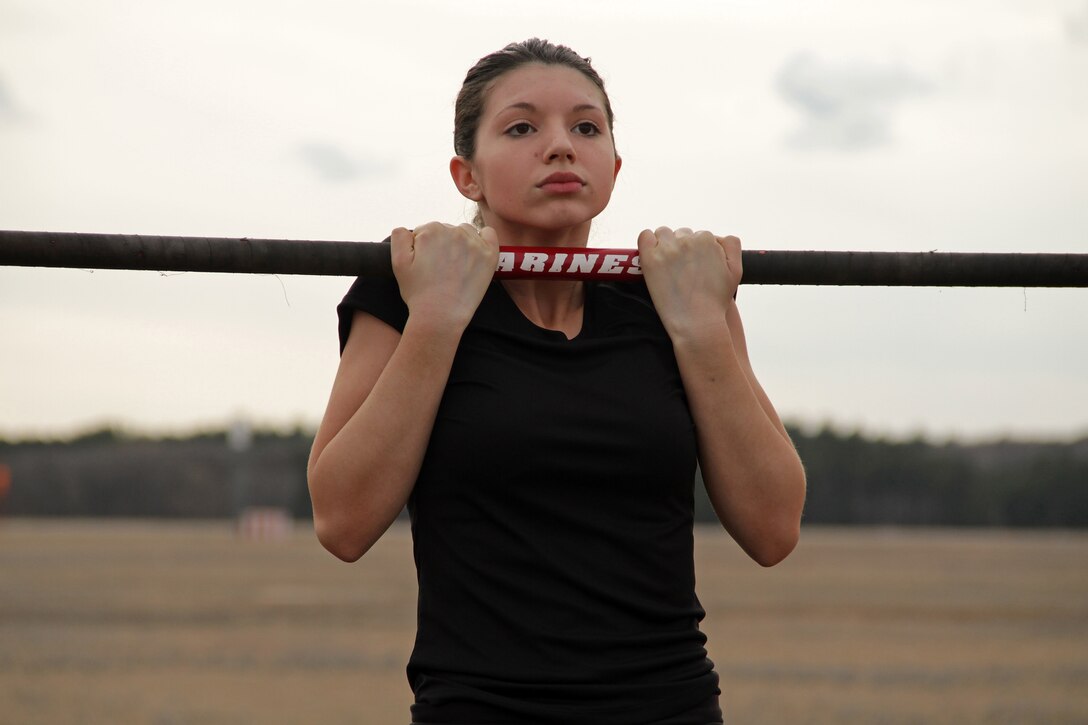 Ariel Arvidson, a 17-year-old junior at Coon Rapids High School, maxes out her time during the flexed-arm hang portion of an initial strength test at the Recruiting Station Twin Cities mini boot camp May 6. Arvidson was recruited out of the Coon Rapids, Minn., office by Staff Sgt. Jowa J. Wildes. For additional imagery from the event, visit www.facebook.com/rstwincities.