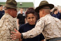Vanessa R. Defender, 17, from Bismarck, N.D., tries to maintain her composure after drill instructor Sgt. Michael S. Bachicha and senior drill instructor Staff Sgt. Salvador Moralessolis catch her smiling at the Recruiting Station Twin Cities mini boot camp May 6. Defender was recruited out of the Bismarck, N.D., office by Sgt. Justin W. Middlemas. For additional imagery from the event, visit www.facebook.com/rstwincities.