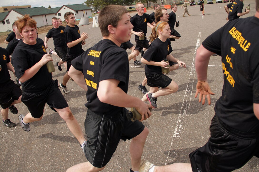 Members of the Delayed Entry Program out of Recruiting Substation Burnsville run toward mock yellow foot prints after meeting their drill instructors for the first time at the Recruiting Station Twin Cities mini boot camp May 6. The Burnsville office brought 56 men and women to attend the three-day boot camp. For additional imagery from the event, visit www.facebook.com/rstwincities.