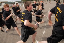 Members of the Delayed Entry Program out of Recruiting Substation Burnsville run toward mock yellow foot prints after meeting their drill instructors for the first time at the Recruiting Station Twin Cities mini boot camp May 6. The Burnsville office brought 56 men and women to attend the three-day boot camp. For additional imagery from the event, visit www.facebook.com/rstwincities.